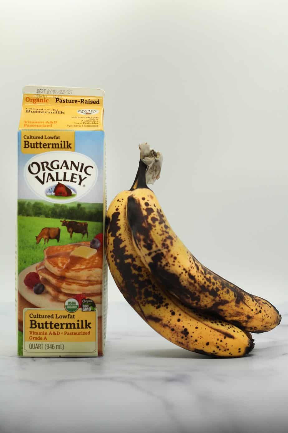 overripe bananas and organic valley buttermilk on a white surface