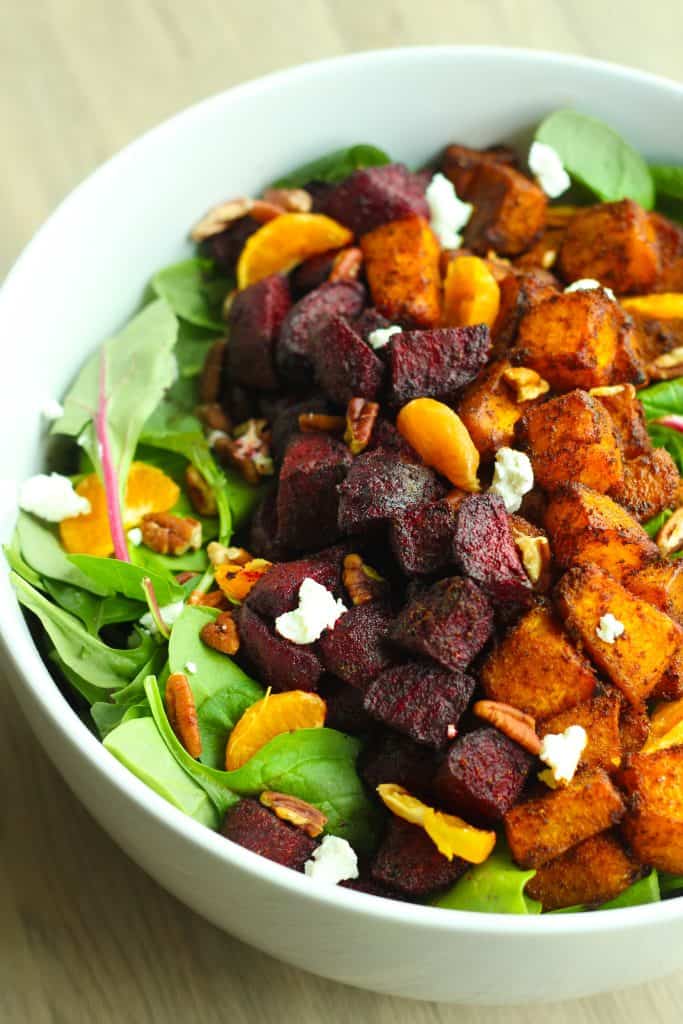 Roasted beetroot and pumpkin salad in a white bowl.