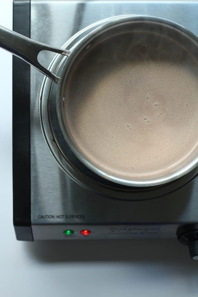 Protein hot chocolate after being heated and whisked in a saucepan.