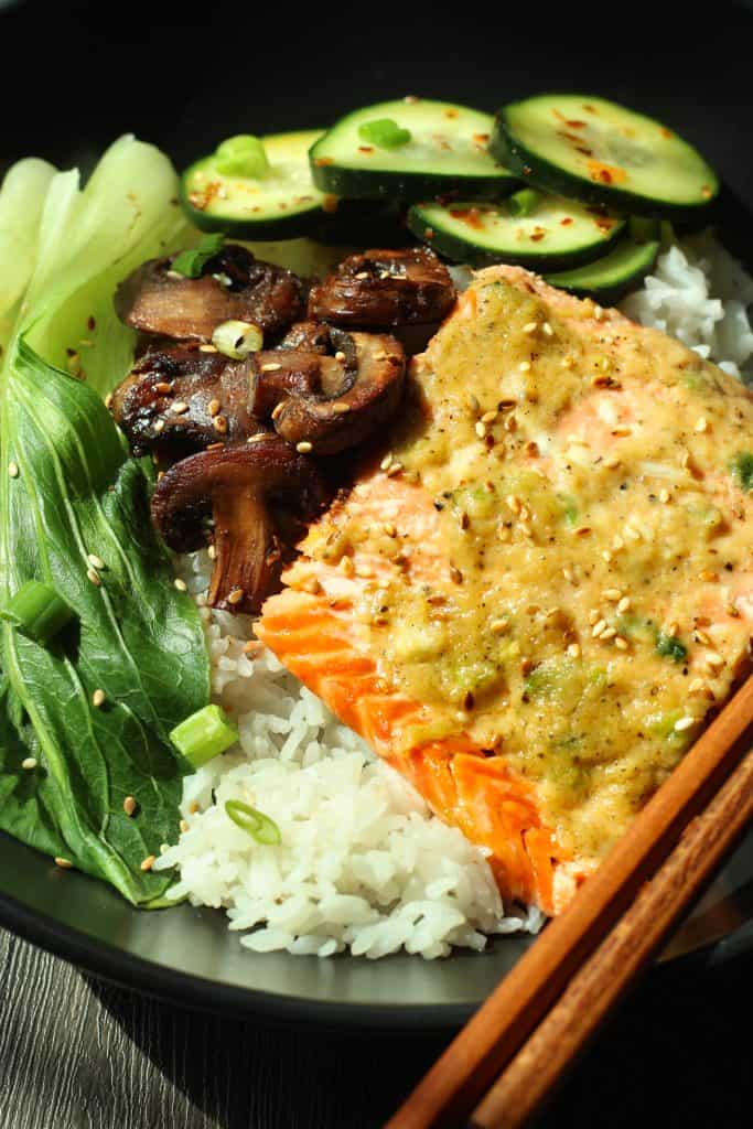 Miso butter salmon over coconut jasmine rice with baby bok choy, sauteed mushrooms, and cucumber salad.