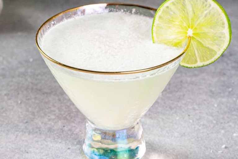 Coconut lime mocktail in a small glass with a lime slice on the rim vegan drinks.