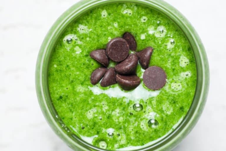 Protein shamrock shake with chocolate chips on tops.