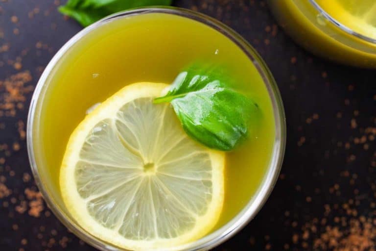 Honeydew melon and basil lemonade garnished with basil and a lemon slice vegan drinks.