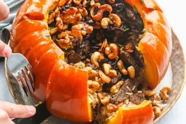 Instant pot stuffed pumpkin cut open with the filling spilling out.