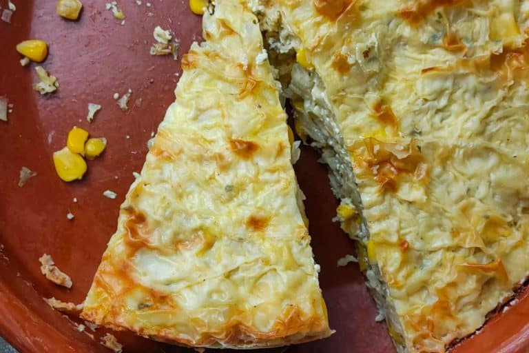 Phyllo cabbage pie sliced on a red plate.
