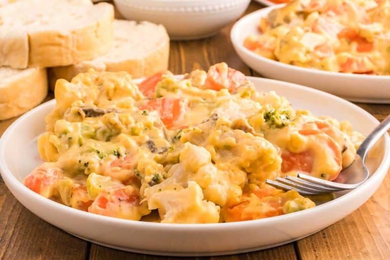 Cheesy vegetable casserole in a white dish for fall potluck dishes.