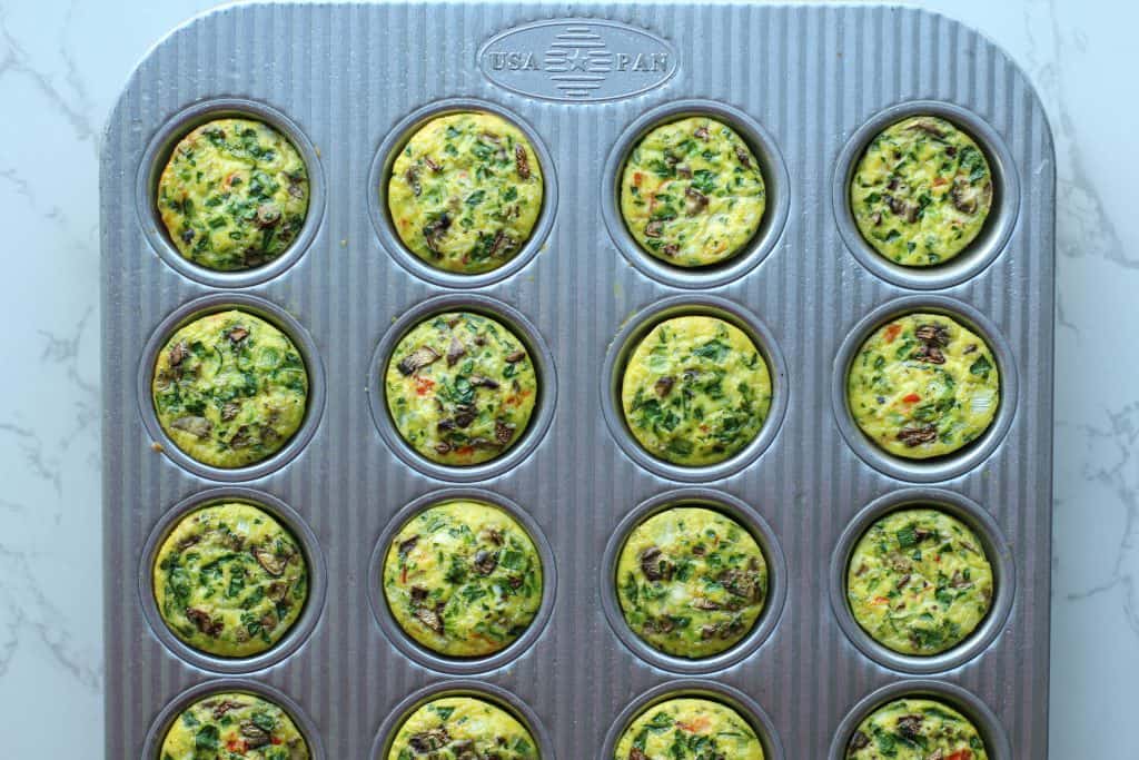 Cooked veggie egg bites in a silver mini muffin USA Pan.