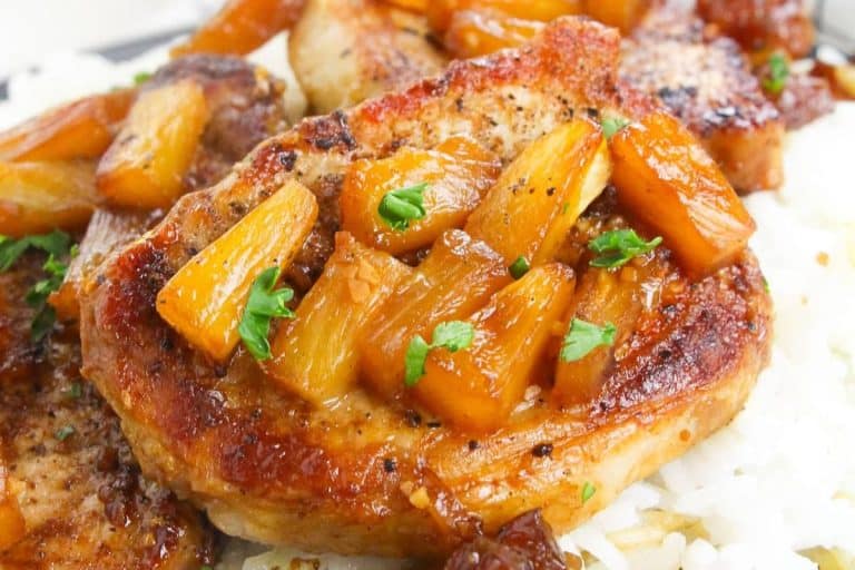 Summer dinner ideas: pineapple pork chops with golden color and sprinkled with fresh parsley.