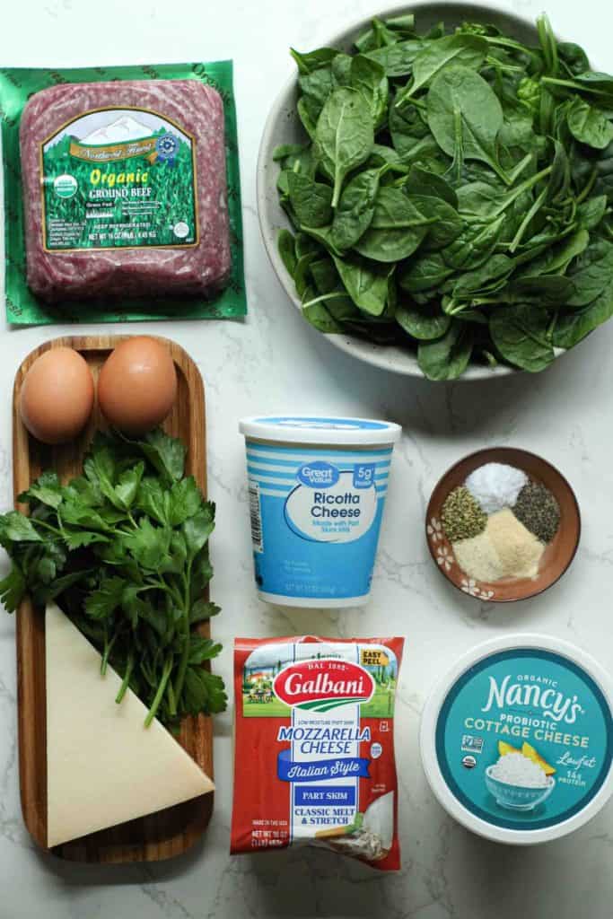 Beef stuffed shells filling ingredients: cottage cheese, mozzarella, parmesan, ricotta, eggs, parsley, ground beef, spinach, seasonings.