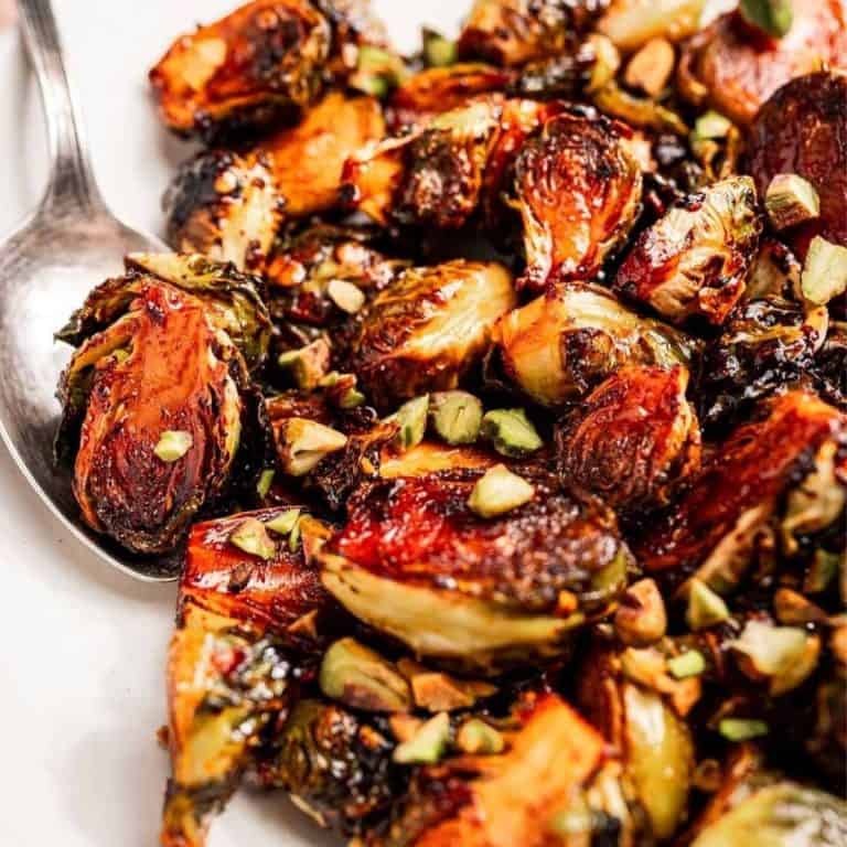 Christmas dinner side dishes maple chili roasted brussels sprouts topped with pistachios.